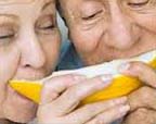 older couple eating mellon
